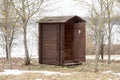 Wooden toilet with opened door