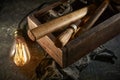 Wooden tool box of used hand tools with old and dirty, rusty wrenches, hammers and old light bulb Royalty Free Stock Photo