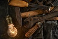 Wooden tool box of used hand tools with old and dirty, rusty wrenches, hammers and old light bulb Royalty Free Stock Photo