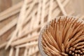 Wooden toothpicks in holder, closeup. Space for text