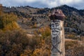 Wooden totem pillar on mountains background in autumn. Orthodox old believers totem.