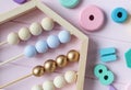 Wooden toy abacus, numbers, blocks, pastel color arc on pink background. Natural no plastic toys for creativity development. Royalty Free Stock Photo