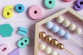 Wooden toy abacus, numbers, blocks, pastel color on pink background. Natural no plastic toys for creativity development. Flat lay Royalty Free Stock Photo