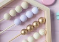 Wooden toy abacus, numbers, blocks, pastel color on pink background. Natural no plastic toys for creativity development. Royalty Free Stock Photo