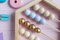 Wooden toy abacus, numbers, blocks, pastel color on pink background. Natural no plastic toys for creativity development. Royalty Free Stock Photo