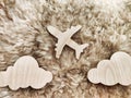 A wooden toy airplane on a beige furry background. The concept of adventure tourism. Love for travel, adventures, and Royalty Free Stock Photo