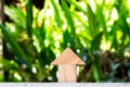 Wooden toy as dream house concept with blur green background Royalty Free Stock Photo