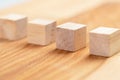 Wooden toy blocks. Geometric wood cubes in a row. Conceptual blank