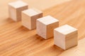 Wooden toy blocks. Geometric wood cubes in a row. Conceptual blank