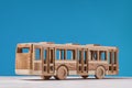 Wooden toy bus on blue background. Royalty Free Stock Photo