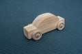 A wooden toy car on a blue mat Royalty Free Stock Photo