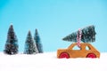 Wooden toy car carrying Christmas tree Royalty Free Stock Photo