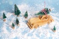 Wooden toy car with Christmas tree on the roof on blue snow back Royalty Free Stock Photo