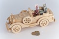 Wooden toy car with coins and euro bills inside Royalty Free Stock Photo