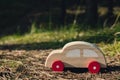 Wooden toy car on greenery forest background. Eco-car concept World car free day electric vehicle environment automobile