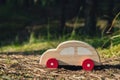 Wooden toy car on greenery forest background. Eco-car concept World car free day electric vehicle environment automobile