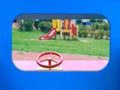 Wooden toy car in the playground for children. Red metal steering wheel of children`s wooden car on the playground Royalty Free Stock Photo