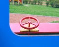 Wooden toy car in the playground for children. Red metal steering wheel of children`s wooden car on the playground Royalty Free Stock Photo