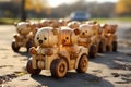 Wooden toy cars with teddy bears on them driving on a sandy beach. A nature view in the background. Copy space.