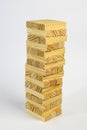 Wooden toy cubes lined up in the form of a tower on a white background Royalty Free Stock Photo