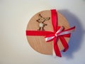 Wooden toy deer wooden on a round box with a bow