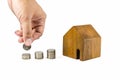 Wooden toy house with coins concept