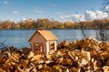 Wooden toy house on the shore of a beautiful lake, the concept of building your own house, an eco-friendly house Royalty Free Stock Photo