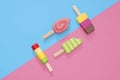 Ice Cream Popsicles Lollipops on blue and pink pastel background