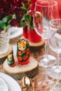 Wooden toy - matryoshka. Table setting in national Russian style. Red in decor and decoration.