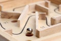 Wooden toy maze with metal ball, closeup