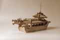 Wooden toy model of an old ship with carved dragons on the bow deck