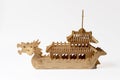 Wooden toy model of an old ship with carved dragons on the bow deck