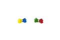 Wooden toy people stand in pairs. Blue and yellow, red and green. The idea of friendship. Board game parts meeples. Royalty Free Stock Photo