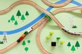 Wooden toy railway with a train, top view. Children toys, a train with wagons traveling in a green meadow with a river. Royalty Free Stock Photo