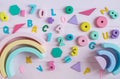 Wooden toy rainbow, numbers, blocks, pastel color arc on pink background. Natural no plastic toys for creativity development. Royalty Free Stock Photo