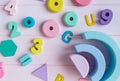 Wooden toy rainbow, numbers, blocks, pastel color arc on pink background. Natural no plastic toys for creativity development. Royalty Free Stock Photo