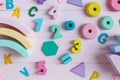 Wooden toy rainbow, numbers, blocks, pastel color arc on pink background. Natural no plastic toys for creativity development. Royalty Free Stock Photo