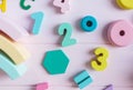 Wooden toy rainbow, numbers, blocks, pastel color arc on pink background. Natural no plastic toys for creativity development. Royalty Free Stock Photo