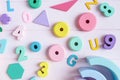 Wooden toy rainbow, numbers, blocks, pastel color arc on pink background. Natural no plastic toys for creativity development. Royalty Free Stock Photo