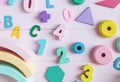 Wooden toy rainbow, numbers, blocks, pastel color arc on pink background. Natural no plastic toys for creativity development Royalty Free Stock Photo