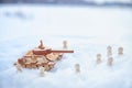 A wooden toy Russian tank T-34 and little men in the snow. Russia and Ukraine are at war in winter. Encirclement Royalty Free Stock Photo