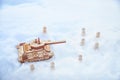 A wooden toy Russian tank T-34 and little men in the snow. Russia and Ukraine are at war in winter. Encirclement Royalty Free Stock Photo