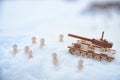 A wooden toy Russian tank T-34 and little men in the snow. Russia and Ukraine are at war in winter. Encirclement Royalty Free Stock Photo