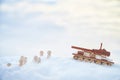 A wooden toy Russian tank T-34 and little men in the snow. Russia and Ukraine are at war in winter. Encirclement Royalty Free Stock Photo