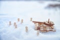 A wooden toy Russian tank T-34 and little men in the snow. Russia and Ukraine are at war in winter. Encirclement Royalty Free Stock Photo