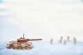 A wooden toy Russian tank T-34 and little men in the snow. Russia and Ukraine are at war in winter. Encirclement Royalty Free Stock Photo