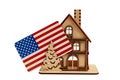 Wooden toy symbolic house with a chimney and a USA flag on white isolated background Royalty Free Stock Photo