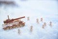 A wooden toy tank and little men in the snow. Russia and Ukraine are at war in winter. Encirclement, retreat, attack Royalty Free Stock Photo