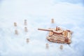 A wooden toy tank and little men in the snow. Russia and Ukraine are at war in winter. Encirclement, retreat, attack Royalty Free Stock Photo