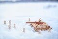 A wooden toy tank and little men in the snow. Russia and Ukraine are at war in winter. Encirclement, retreat, attack Royalty Free Stock Photo